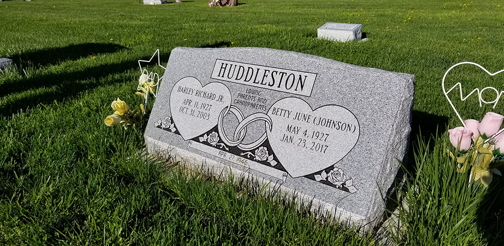 Double 2ft. slant style headstone with hearts and wedding rings in gray granite