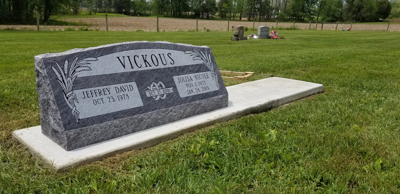 Double 4ft. slant style headstone with wedding rings in blue silk granite